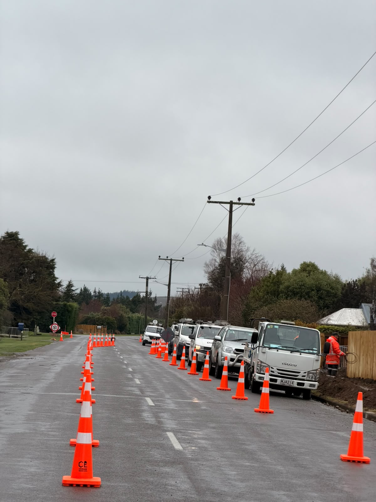 A traffic management setup protecting roadside work in wet conditions